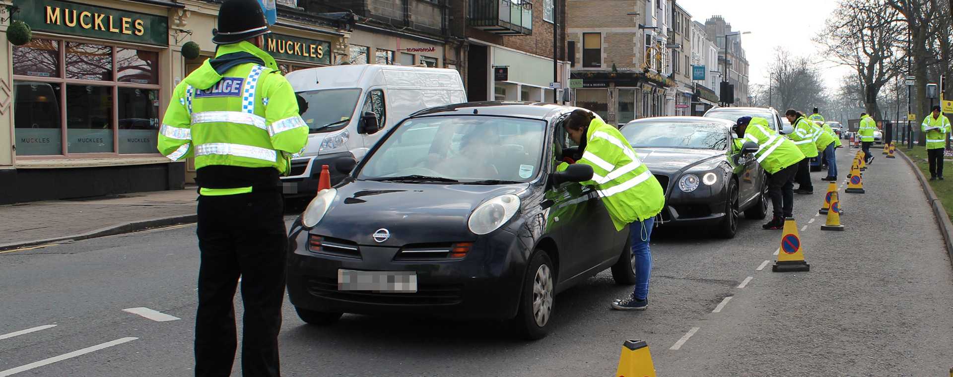 Tracsis Events staff converse with motorists whilst conducting a survey.
