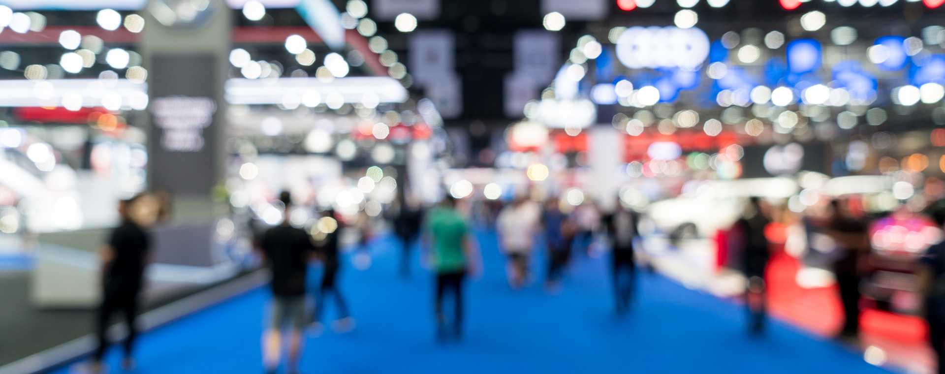 A soft focus image of attendees at a trade show