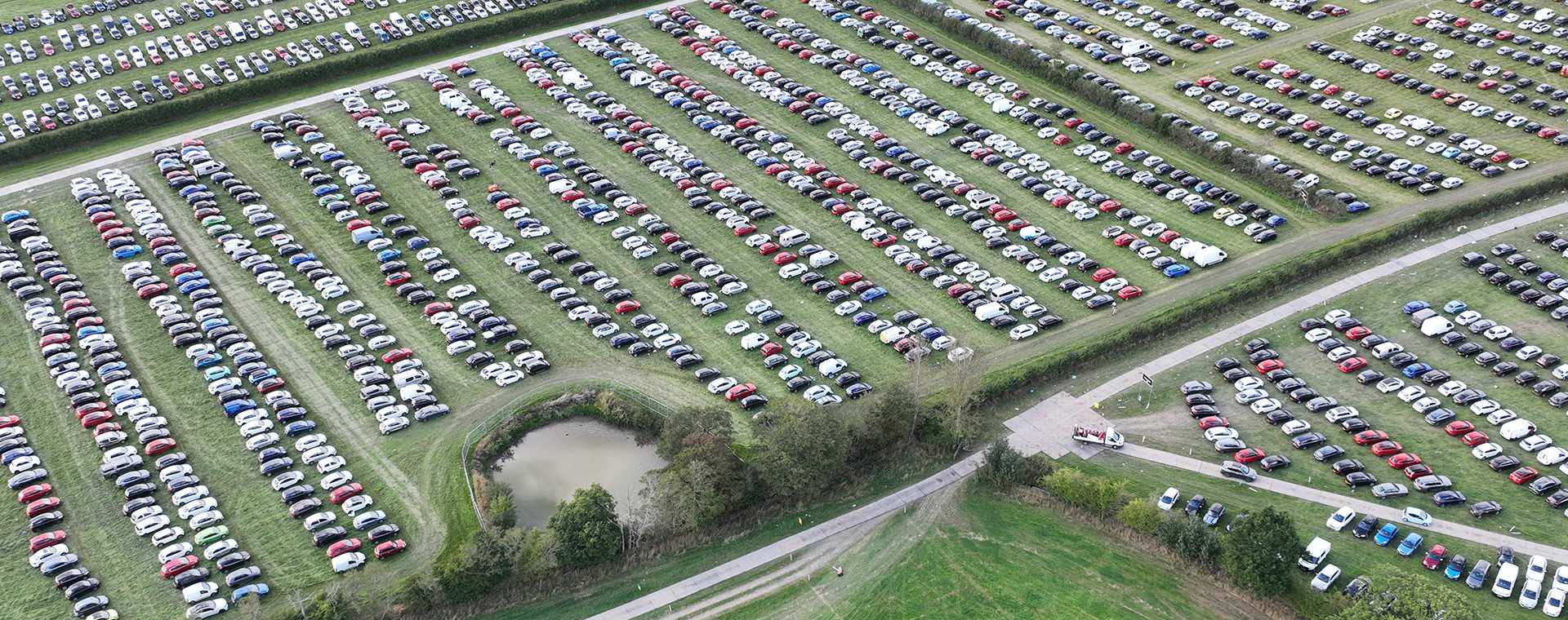 Aerial photograph of cars parked in a field